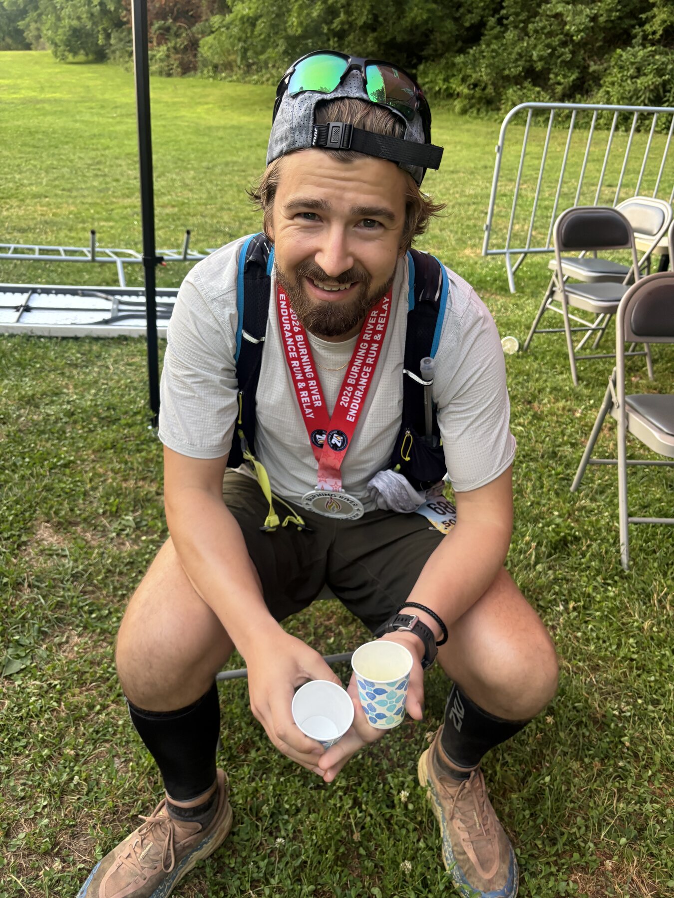 Smiling after finishing the Burning River 50 with a finisher medal
