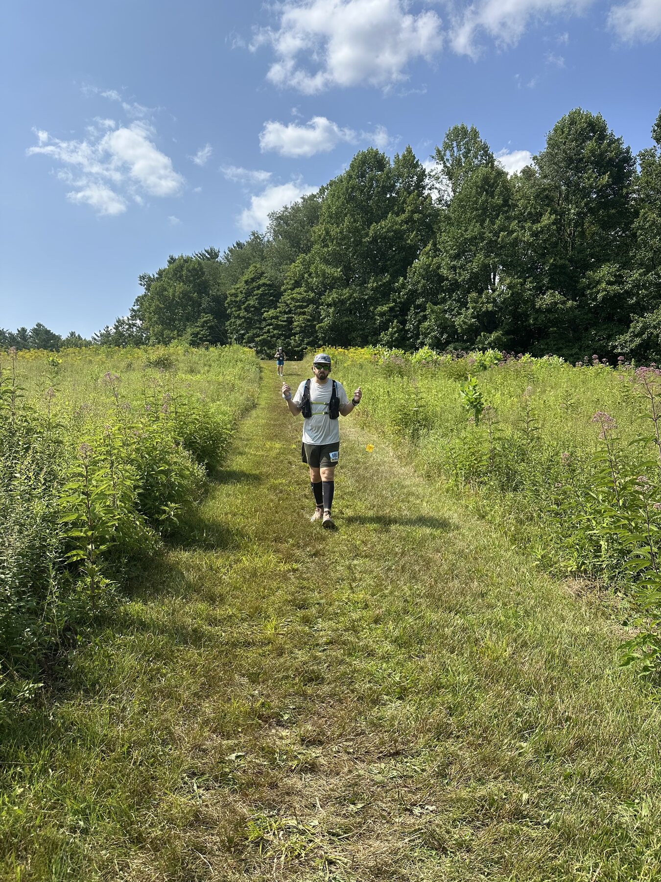 Running through a sunny meadow during the Burning River 50
